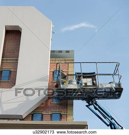 Stock Image - Man doing renovation work at Hollywood Wax Museum, Branson, Taney County, Missouri, USA. Fotosearch