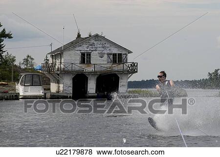 Man waterskiing in a lake, Lake of The Woods, Keewatin, Ontario, Canada View Large Photo Image Stock Photo - Man waterskiing in a lake, Lake of The Woods, Keewatin, Ontario, Canada. Fotosearch