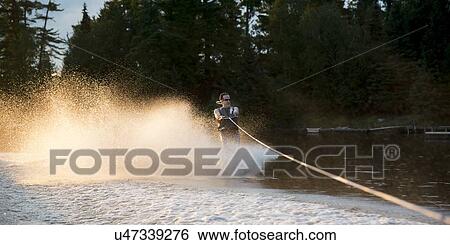 Stock Photograph - Man waterskiing in a lake, Lake of The Woods, Keewatin, Ontario, Canada. Fotosearch