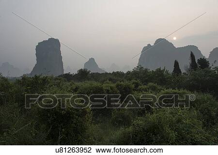 Stock Image - Mountains at dusk, Yangshuo, Guilin, Guangxi Province, China. Fotosearch