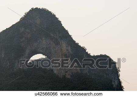 Natural arch on a hill, Moon Hill, Yangshuo, Guilin, Guangxi Province, China View Large Photo Image Stock Photograph - Natural arch on a hill, Moon Hill, Yangshuo, Guilin, Guangxi Province, China. Fotosearch
