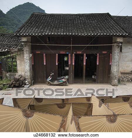 Stock Image - Painted fans in front of a house, Fuli Village, Yangshuo, Guilin, Guangxi Province, China. Fotosearch