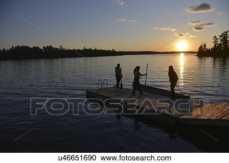 People on a dock at sunset, Lake Of The Woods, Keewatin, Ontario, Canada View Large Photo Image Stock Image - People on a dock at sunset, Lake Of The Woods, Keewatin, Ontario, Canada. Fotosearch
