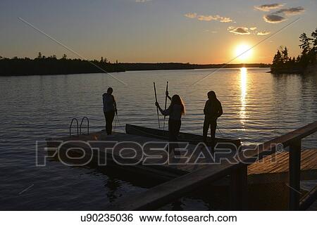 People on a dock at sunset, Lake Of The Woods, Keewatin, Ontario, Canada View Large Photo Image Stock Photograph - People on a dock at sunset, Lake Of The Woods, Keewatin, Ontario, Canada. Fotosearch