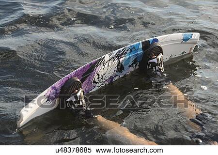 Stock Photography - Person's feet with wakeboard in water, Lake of The Woods, Keewatin, Ontario, Canada. Fotosearch
