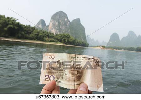 Person's hand showing a Chinese yuan note, Li River, Xingping, Yangshuo, Guilin, Guangxi Province, China View Large Photo Image Stock Image - Person's hand showing a Chinese yuan note, Li River, Xingping, Yangshuo, Guilin, Guangxi Province, China. Fotosearch
