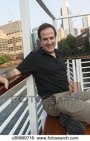Portrait of a man sitting in a boat and smiling, Canal Street, Chicago, Cook County, Illinois, USA View Large Photo Image Stock Photograph - Portrait of a man sitting in a boat and smiling, Canal Street, Chicago, Cook County, Illinois, USA. Fotosearch