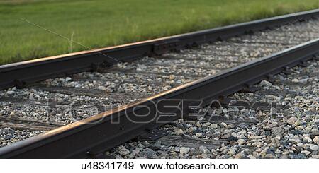 Stock Photo - Railroad tracks passing through a prairie field, Manitoba, Canada. Fotosearch