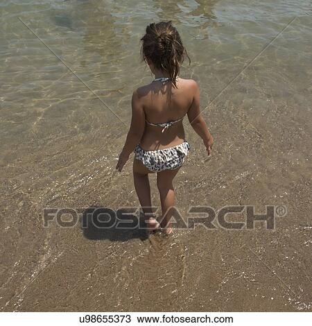 Rear view of a girl walking on the beach, Chicago, Cook County, Illinois, USA View Large Photo Image Stock Image - Rear view of a girl walking on the beach, Chicago, Cook County, Illinois, USA. Fotosearch