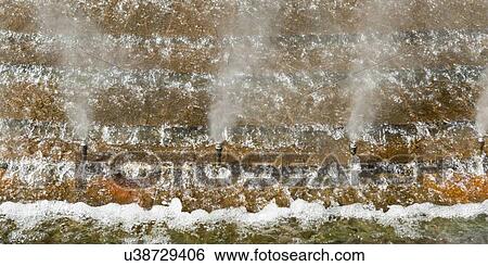 Stock Photograph - Sprinklers spraying in a fountain at the entrance to Universal Studios, Orlando, Florida, USA. Fotosearch