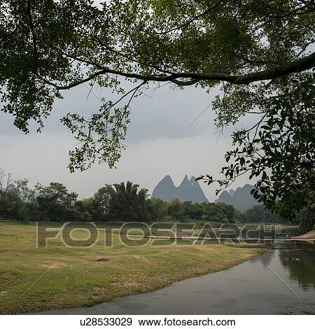 Stock Photo - Stream with mountain in the background, Fuli Village, Yangshuo, Guilin, Guangxi Province, China. Fotosearch