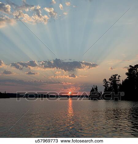 Sunbeam passing through clouds in the sky, Ontario, Canada View Large Photo Image Stock Image - Sunbeam passing through clouds in the sky, Ontario, Canada. Fotosearch