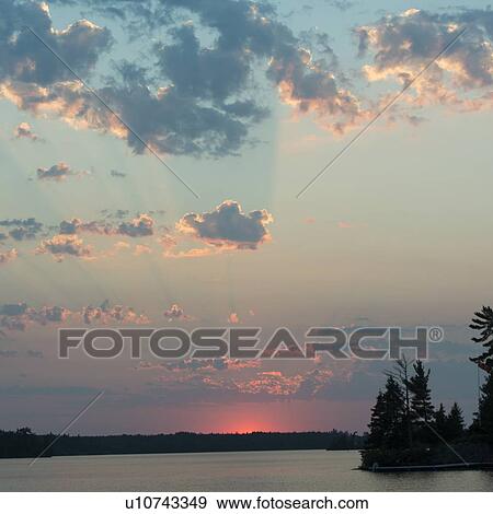 Stock Photo - Sunrise over a lake, Lake of The Woods, Ontario, Canada. Fotosearch