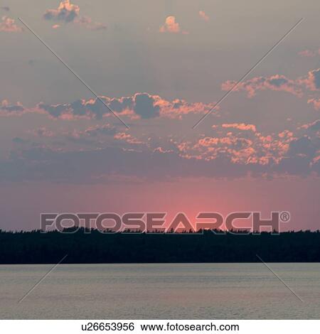 Sunrise over a lake, Lake of The Woods, Ontario, Canada View Large Photo Image Stock Photograph - Sunrise over a lake, Lake of The Woods, Ontario, Canada. Fotosearch
