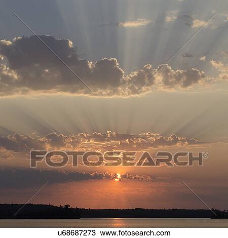 Stock Image - Sunset over a lake, Lake of The Woods, Ontario, Canada. Fotosearch
