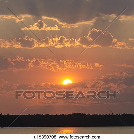 Stock Photo - Sunset over a lake, Lake of The Woods, Ontario, Canada. Fotosearch