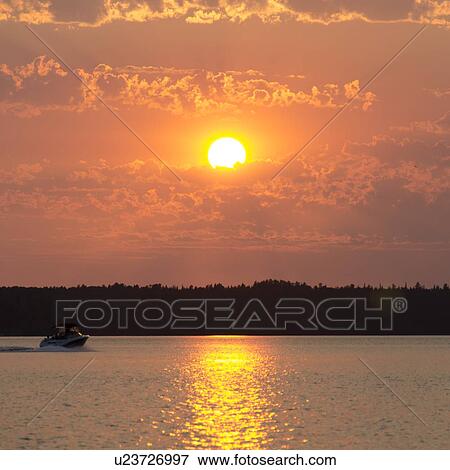 Stock Photo - Sunset over a lake, Lake of The Woods, Ontario, Canada. Fotosearch