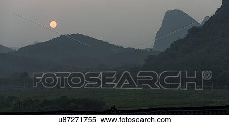 Sunset over mountain, Yangshuo, Guilin, Guangxi Province, China View Large Photo Image Stock Photography - Sunset over mountain, Yangshuo, Guilin, Guangxi Province, China. Fotosearch