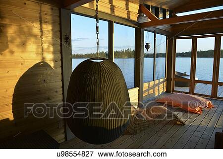 Swing chair on a dock, Lake of The Woods, Keewatin, Ontario, Canada View Large Photo Image Stock Photo - Swing chair on a dock, Lake of The Woods, Keewatin, Ontario, Canada. Fotosearch
