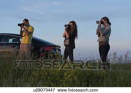 Three friends taking pictures, Manitoba, Canada View Large Photo Image Stock Photo - Three friends taking pictures, Manitoba, Canada. Fotosearch