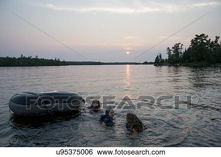 Three girls enjoying in the lake with inflatable raft, Lake Of The Woods, Keewatin, Ontario, Canada View Large Photo Image Stock Photograph - Three girls enjoying in the lake with inflatable raft, Lake Of The Woods, Keewatin, Ontario, Canada. Fotosearch