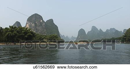 Stock Photo - Tourboats in the Li River with mountains in the background, Yangshuo, Guilin, Guangxi Province, China. Fotosearch