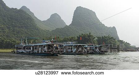 Tourboats in the Li River, Yangshuo, Guilin, Guangxi Province, China View Large Photo Image Stock Photo - Tourboats in the Li River, Yangshuo, Guilin, Guangxi Province, China. Fotosearch
