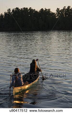 Stock Image - Tourists boating in a lake, Lake of The Woods, Keewatin, Ontario, Canada. Fotosearch
