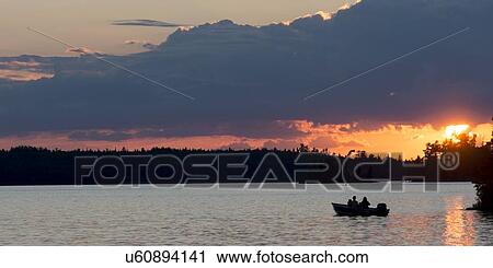 Stock Image - Tourists boating in the Lake Of The Woods, Keewatin, Ontario, Canada. Fotosearch
