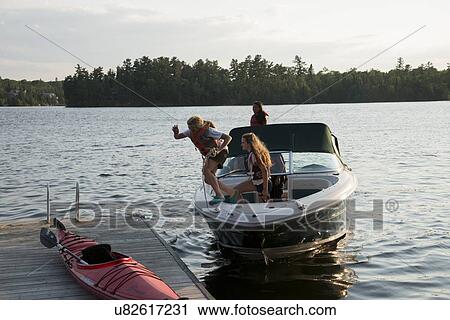 Tourists enjoying on a motorboat in a lake, Lake of The Woods, Keewatin, Kenora, Ontario, Canada View Large Photo Image Stock Image - Tourists enjoying on a motorboat in a lake, Lake of The Woods, Keewatin, Kenora, Ontario, Canada. Fotosearch