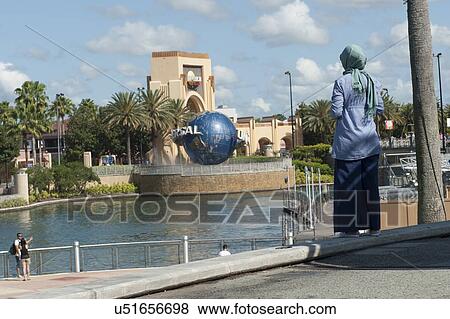 Stock Photo - Tourists looking at Universal Studios Entrance, Orlando, Florida, USA. Fotosearch