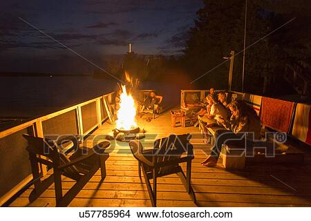 Tourists near a campfire, Lake of The Woods, Keewatin, Ontario, Canada View Large Photo Image Picture - Tourists near a campfire, Lake of The Woods, Keewatin, Ontario, Canada. Fotosearch