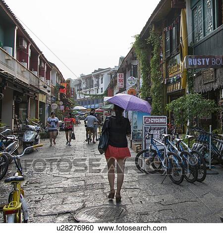 Tourists on a street, West Street, Yangshuo, Guilin, Guangxi Province, China View Large Photo Image Stock Image - Tourists on a street, West Street, Yangshuo, Guilin, Guangxi Province, China. Fotosearch
