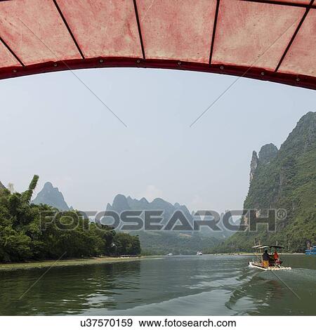 Stock Photo - Tourists on a tourboat, Li River, Yangshuo, Guilin, Guangxi Province, China. Fotosearch
