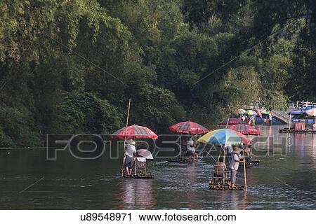 Tourists on bamboo rafts, Yulong River, Yangshuo, Guilin, Guangxi Province, China View Large Photo Image Stock Image - Tourists on bamboo rafts, Yulong River, Yangshuo, Guilin, Guangxi Province, China. Fotosearch
