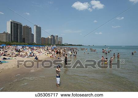 Stock Photo - Tourists on the beach, Lake Michigan, Chicago, Cook County, Illinois, USA. Fotosearch