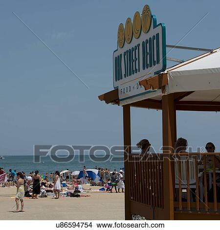 Picture - Tourists on the Oak Street Beach, Lake Shore Drive, Lake Michigan, Chicago, Cook County, Illinois, USA. Fotosearch