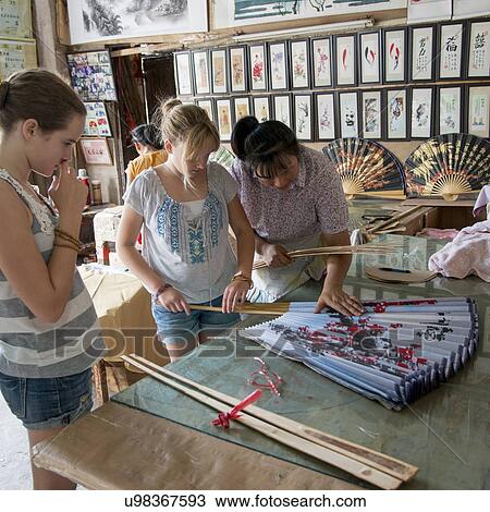 Tourists shopping in a store, Fuli Village, Yangshuo, Guilin, Guangxi Province, China View Large Photo Image Stock Image - Tourists shopping in a store, Fuli Village, Yangshuo, Guilin, Guangxi Province, China. Fotosearch