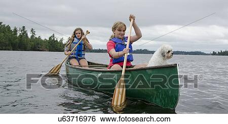 Two girls rowing a boat in a lake, Lake of The Woods, Ontario, Canada View Large Photo Image Stock Photograph - Two girls rowing a boat in a lake, Lake of The Woods, Ontario, Canada. Fotosearch