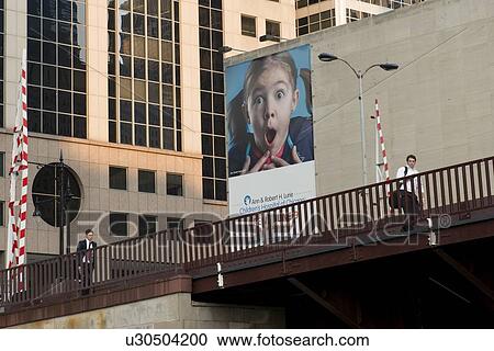 Stock Image - Two men walking on a bridge, Chicago, Cook County, Illinois, USA. Fotosearch