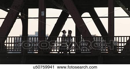 Two women walking on a bridge, Chicago, Cook County, Illinois, USA View Large Photo Image Stock Image - Two women walking on a bridge, Chicago, Cook County, Illinois, USA. Fotosearch