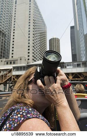 Woman photographing with a digital camera, Chicago, Cook County, Illinois, USA View Large Photo Image Stock Photo - Woman photographing with a digital camera, Chicago, Cook County, Illinois, USA. Fotosearch