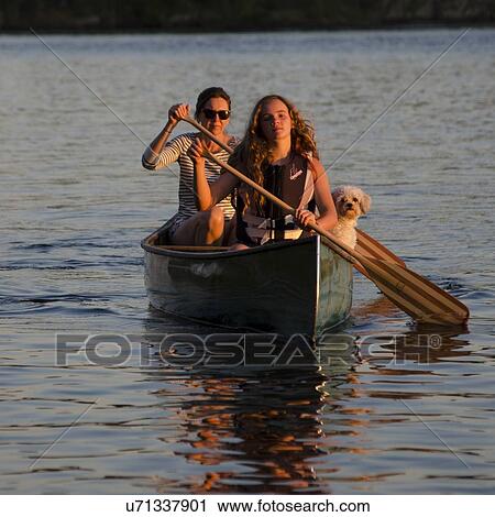 Woman rowing a boat with her daughter, Lake of The Woods, Keewatin, Ontario, Canada View Large Photo Image Stock Image - Woman rowing a boat with her daughter, Lake of The Woods, Keewatin, Ontario, Canada. Fotosearch