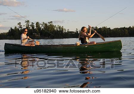 Woman rowing a boat with her daughter, Lake of The Woods, Keewatin, Ontario, Canada View Large Photo Image Stock Image - Woman rowing a boat with her daughter, Lake of The Woods, Keewatin, Ontario, Canada. Fotosearch