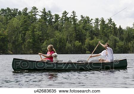 Woman rowing a boat with her daughter, Lake of The Woods, Keewatin, Ontario, Canada View Large Photo Image Stock Photography - Woman rowing a boat with her daughter, Lake of The Woods, Keewatin, Ontario, Canada. Fotosearch