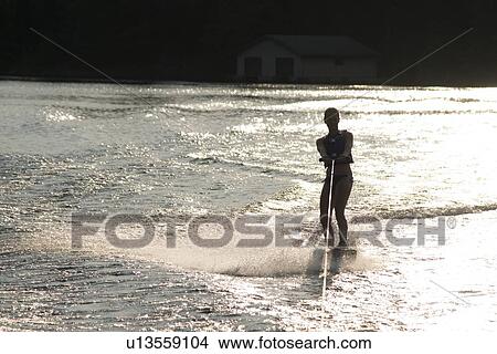 Woman waterskiing at Lake of The Woods, Keewatin, Ontario, Canada View Large Photo Image Picture - Woman waterskiing at Lake of The Woods, Keewatin, Ontario, Canada. Fotosearch