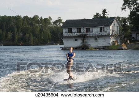Picture - Woman waterskiing in a lake, Lake of The Woods, Keewatin, Ontario, Canada. Fotosearch