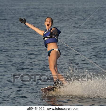 Stock Image - Woman waterskiing in a lake, Lake of The Woods, Keewatin, Ontario, Canada. Fotosearch