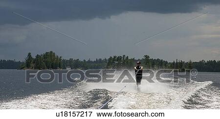 Woman waterskiing in a lake, Lake of The Woods, Ontario, Canada View Large Photo Image Stock Photo - Woman waterskiing in a lake, Lake of The Woods, Ontario, Canada. Fotosearch