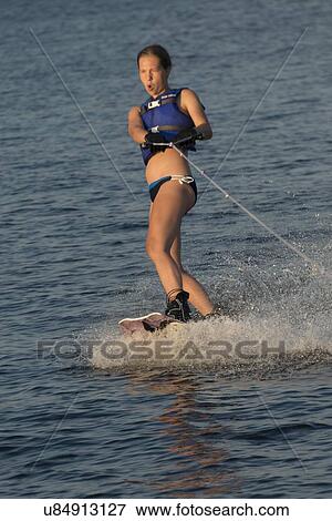 Stock Photo - Woman waterskiing in a lake, Lake of The Woods, Keewatin, Ontario, Canada. Fotosearch